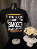 Black shirt with 'Life is too short to smoke bad cigars' text on a dark background