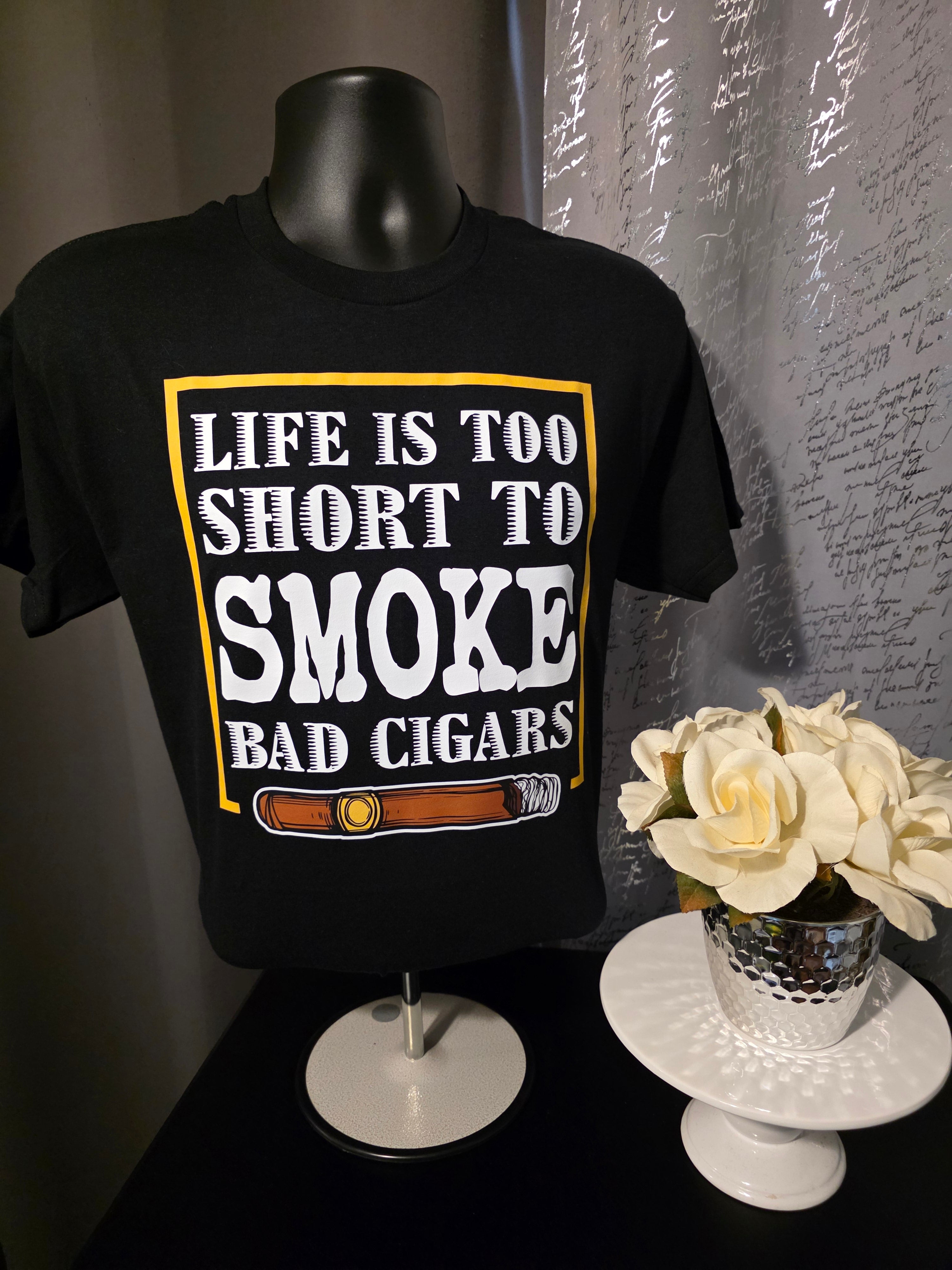 Black shirt with 'Life is too short to smoke bad cigars' text on a dark background