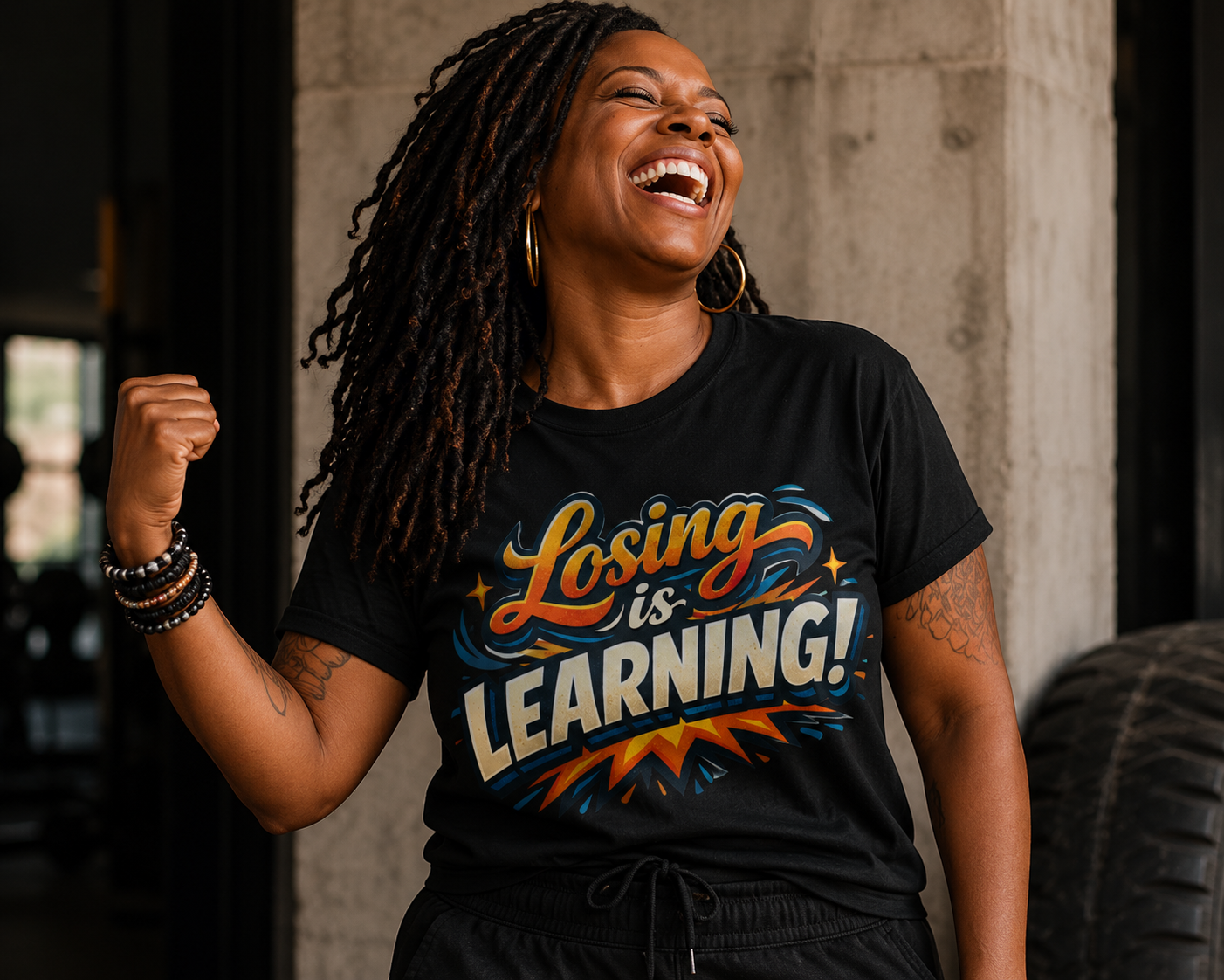 Person wearing a black t-shirt with 'Losing is Learning!' text, standing against a neutral background.